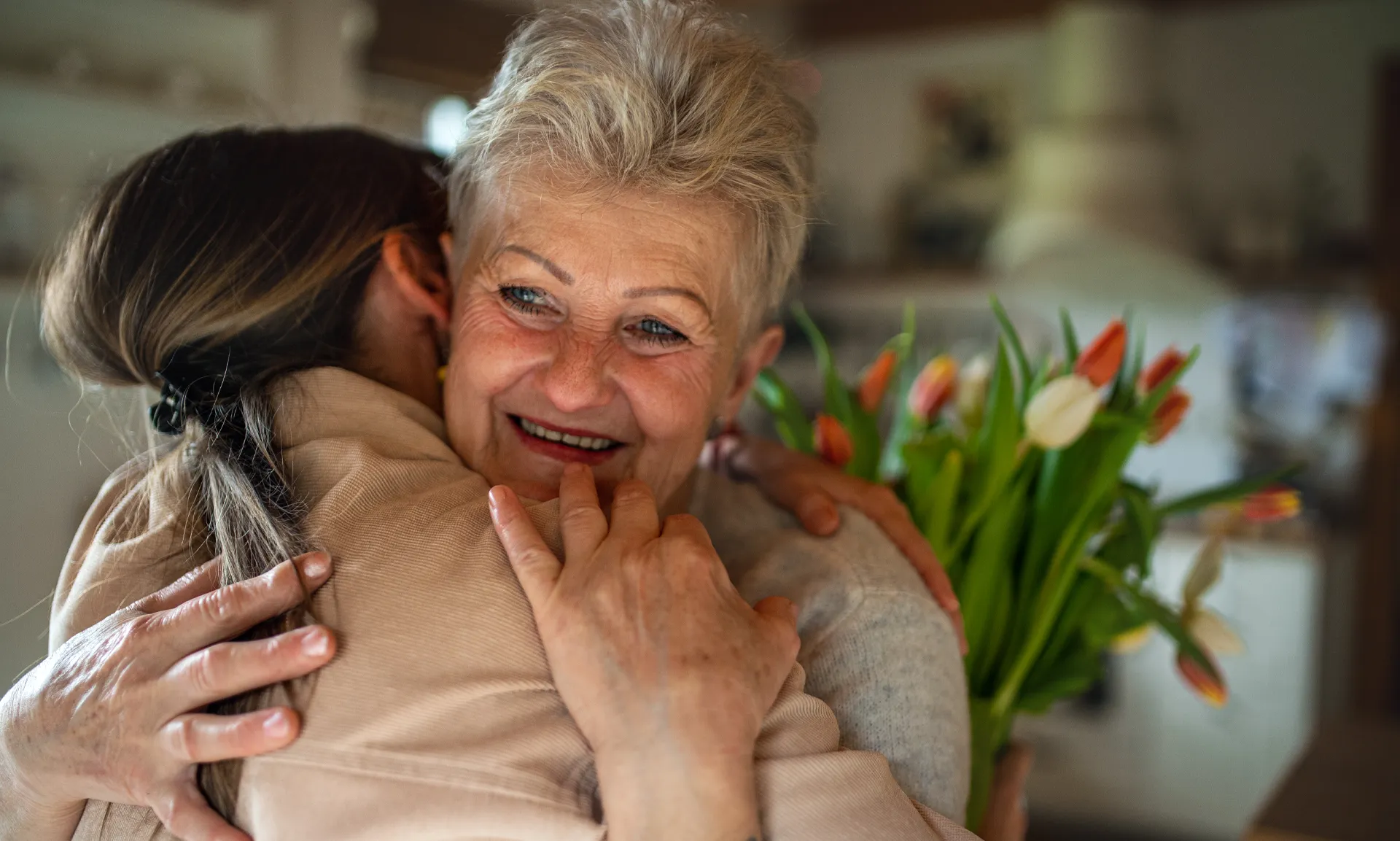 adult daughter hugging her mother
