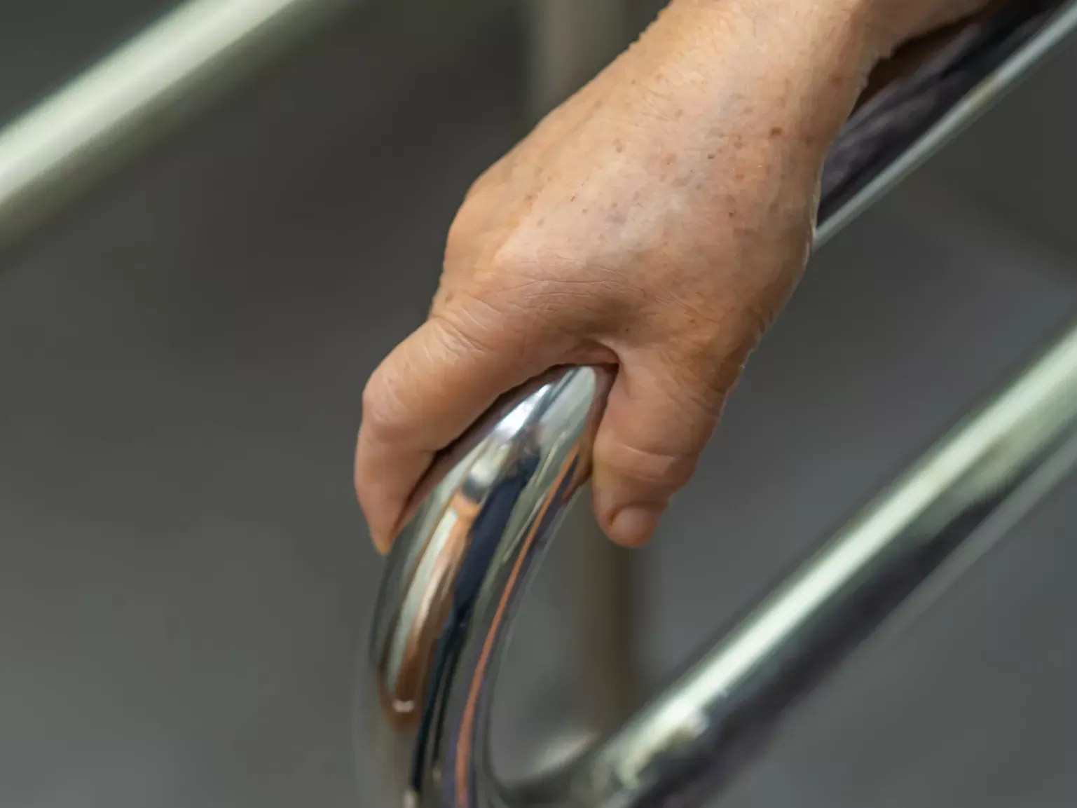 elderly lady uses bathroom handle for her security security