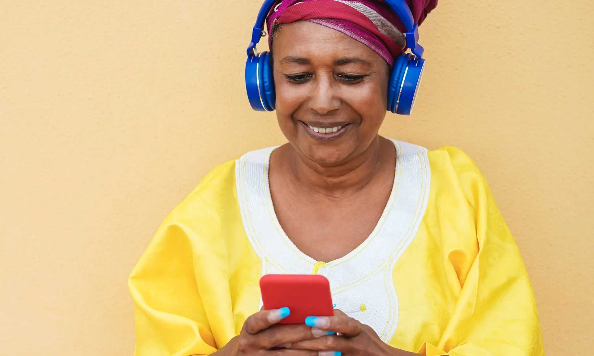 Happy elderly woman listening to playlist music