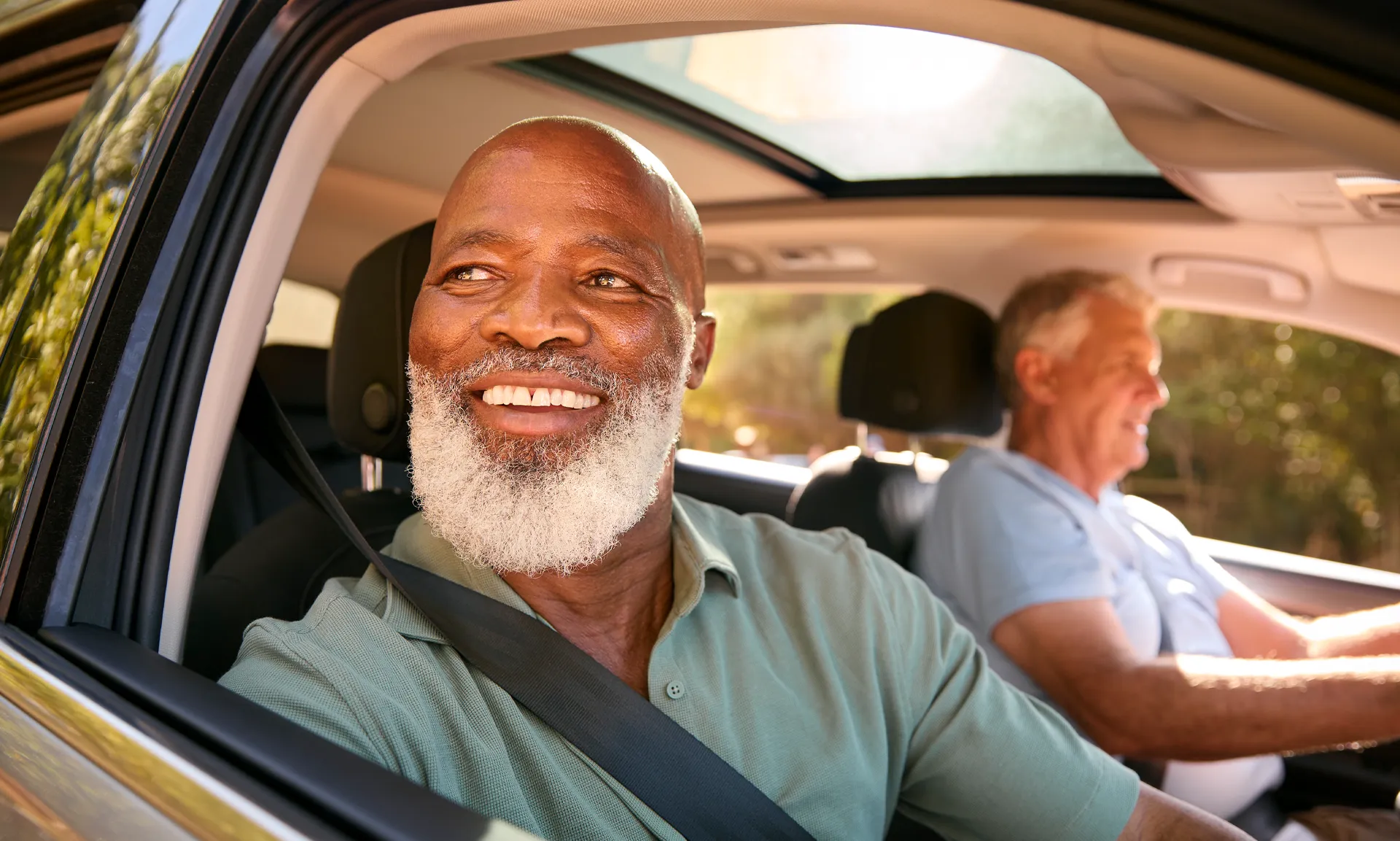 Senior Male Enjoying Day Trip Out In Car